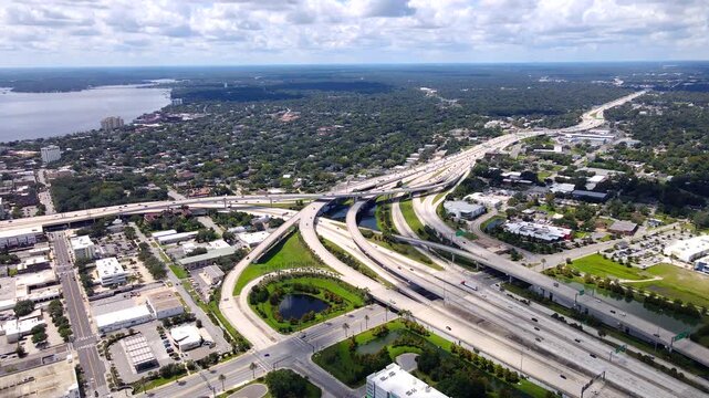 Highway interchange and surrounding Jacksonville neighborhoods appear in panoramic 4K drone video
