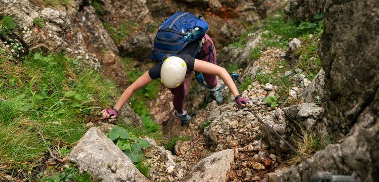 Female Via Ferrata Climber Ascending Steep Rocky Route Using Steel Safety Cable in Rax Alps Austria