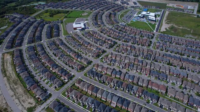 Real estate project construction site in America. Townhouses and Housing building development in North America. Homes in strong pattern replicate bee hive clusters look.