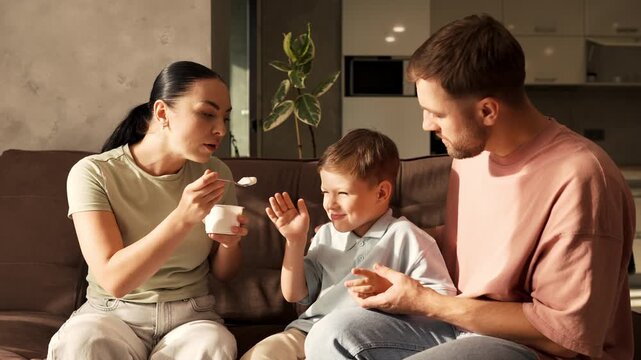 Capricious little boy refusing to eat yogurt