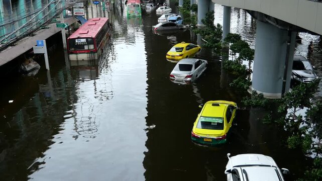 Vehicles stranded on a submerged road in Bangkok. Bangkok Flash floods caused by monsoon rains have turned all 50 districts of Bangkok into official disaster zones.