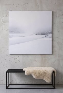 Abstract white landscape painting on a modern black bench  