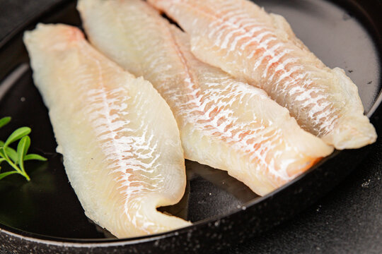 Sea bass fillet raw white fish, seafood healthy eating &nbsp;pescatarian diet healthful tasty dish, snack fresh gourmet rustic food background on the table top view copy space