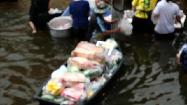 Bangkok Flood Market. Bangkok Flash floods caused by monsoon rains have turned all 50 districts of Bangkok into official disaster zones. Many people are going out shopping despite the flood. 
