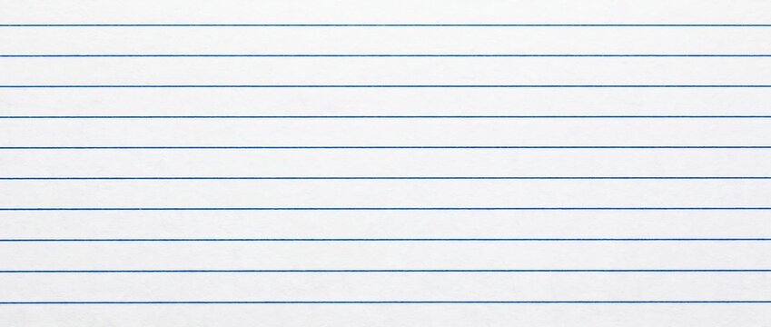 White ruled notebook paper background with blue horizontal lines. Lined school stationery texture