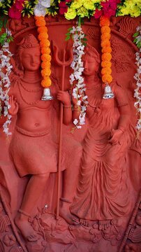 Lord Shiva and Goddess Parvati statue on wall, Hindu deity sculpture, religious home decor