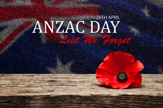 Poppy pin for Anzac Day. Poppy flower on old beautiful high grain, detailed wood on black textured background with text and transparent Australia flag.