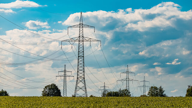 Summer landscape view with overland high voltage lines soon to be replaced by Ostbayernachse near Aholming, Deggendorf, Bavaria, Germany