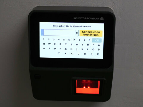 Germany, Paderborn, September 29. 2026, Close-up of a digital touchscreen parking terminal by Scheidt & Bachmann requesting license plate input