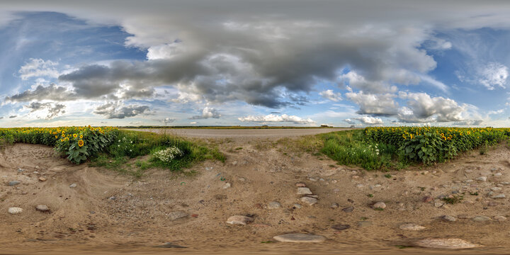full seamless spherical hdri panorama 360 by 180 degrees angle view on gravel road near sunflowers fields in sunny summer evening in equirectangular projection, skybox VR AR virtual reality content
