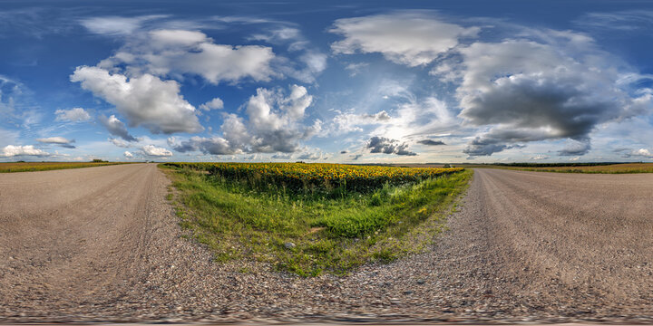 full seamless spherical hdri panorama 360 by 180 degrees angle view on gravel road near sunflowers fields in sunny summer evening in equirectangular projection, skybox VR AR virtual reality content