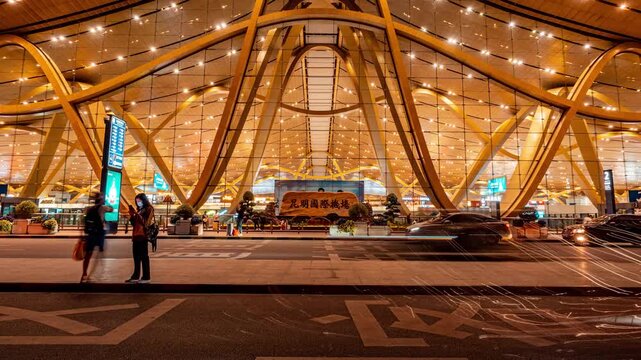 Night View of Modern Kunming Changshui International Airport Terminal Entrance with Travelers and Cars Kunming Changshui International Airport, Kunming, China