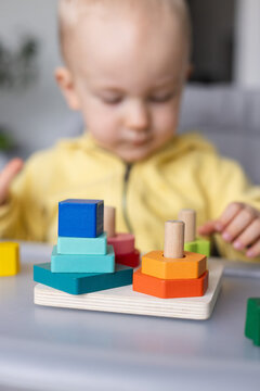 Baby playing with educational toy, Closeup, selective focus.