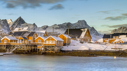 Yellow wooden fishing village in last sunlight in arctic fjord © creativenature.nl