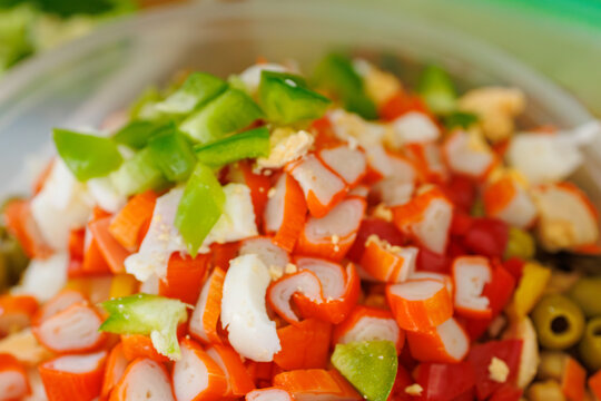 Fresh surimi salad with bell peppers and olives