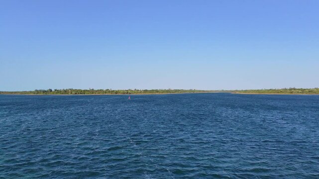 Blue lagoon water with windsurf sail, Jericoacoara, Ceara, Brazil