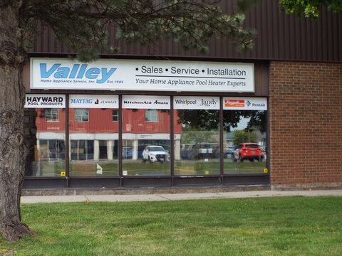 Gloucester, Ontario, Canada &ndash; July 27, 2026: The "Valley Home Appliance Service" storefront features brand signage, large display windows with brand logos, and a brick exterior at  5370 Canotek Rd Uni
