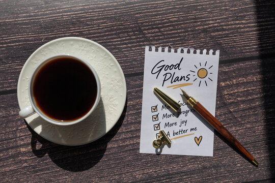 Make It Happen Motivational Message on Notepad with Coffee and Fountain Pen.