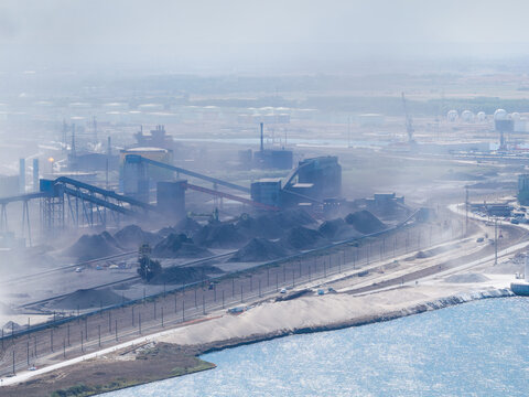 Aerial view. Heavy industrial steel plant with smoke emissions into the atmosphere. Metallurgical manufacturing process and environmental air pollution.
