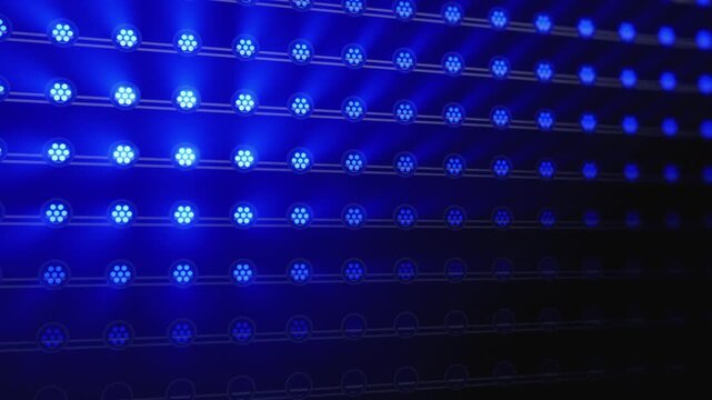 A wall of LED stage lights on truss flashes in programmed chase, wave, and strobe patterns, with beams cutting through atmospheric haze and bloom. Realistic concert and event background.