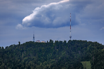 Obraz premium Uetliberg mountain television tower under dramatic clouds in Zurich, Switzerland