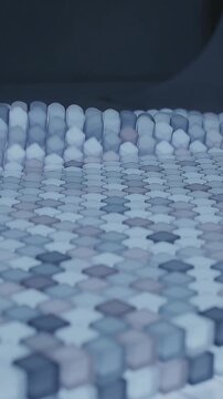Vertical video: Rising caps forming ridge on device on signal, exposing piano keys for touch cue