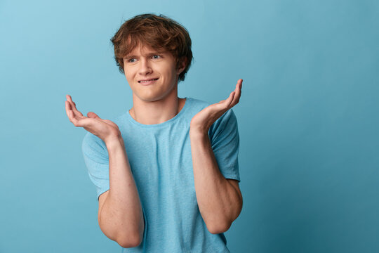 Shrugging man with raised palms expressing uncertainty against a blue backdrop. Clear concept for explainer visuals, decision making, and customer service communications.