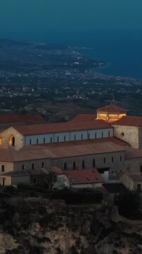 The great cathedral of Gerace, illuminated at night, at the first light of dawn