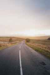 Obraz premium Golden hour light across rolling moorland outside Lanehead in Northumberland National Park during early autumn September 2026