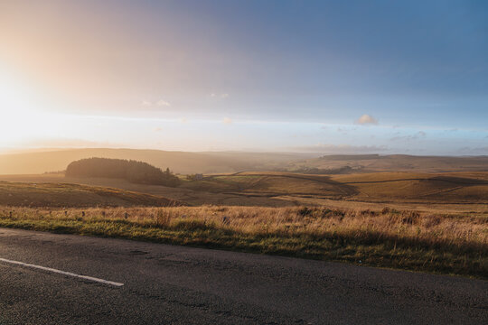 Golden hour light across rolling moorland outside Lanehead in Northumberland National Park during early autumn September 2026