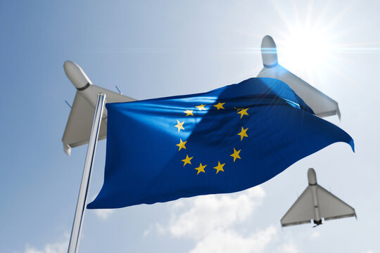 Military drones flying over the waving European Union flag against a bright sunny sky, representing EU defense, military technology, security, and air defense preparedness.