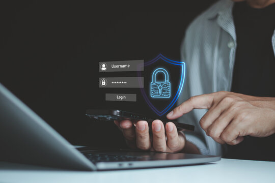 Person using smartphone with digital security shield password icon over laptop, cybersecurity, data protection, secure login, mobile authentication, online privacy for modern business technology.