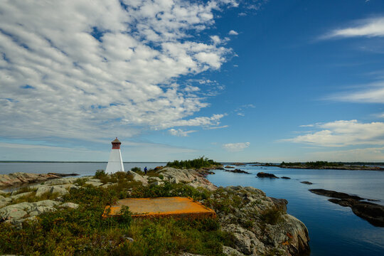 Historic range light on a granite point with low shrubs, orange lichen and a calm blue channel, copy space, Bustard Islands, Georgian Bay, Ontario