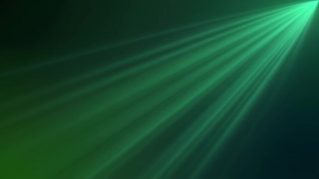 Soft emerald green light rays spreading slowly through a dark background