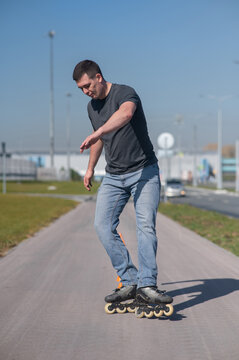 A Caucasian man rollerblades around the slalom course.