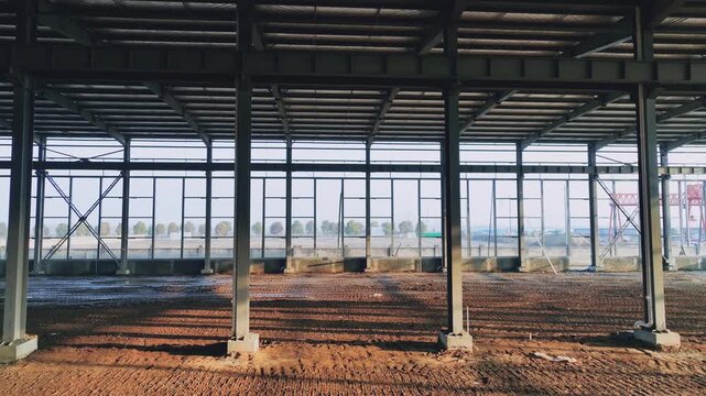 Steel Structure Warehouse Under Construction with Dirt Floor and Crane