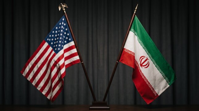 United States and Iran flags displayed together on poles against a dark curtain background symbolizing diplomacy and international relations