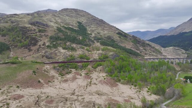 The Jacobite Steam Train on Glenfinnan Viaduct from a drone, Loch Shiel, Glenfinnan, River Finnan, West Highland, Scotland, United Kingdom