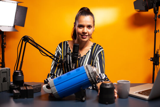 Smiling creator presenting continuous studio light