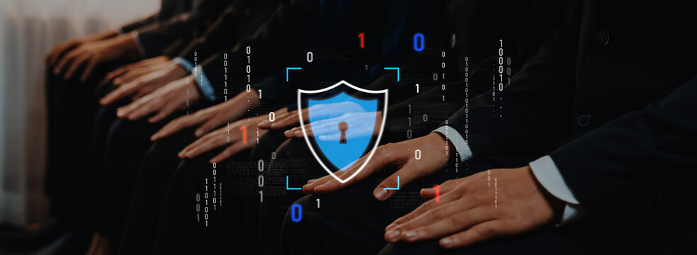 A group of business professionals in suits sit together, symbolizing data protection and cybersecurity. The image blends human connection with digital security themes. Trope