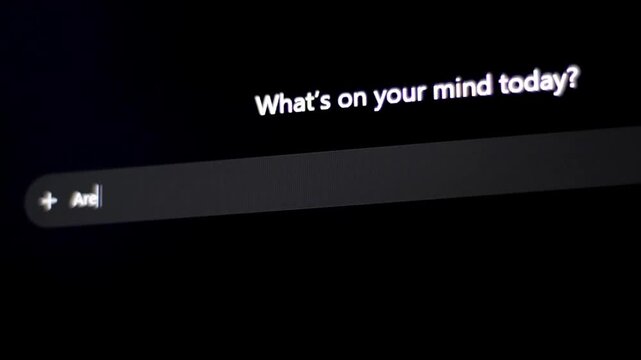 Close-up of computer screen showing text input field with user typing question for AI chatbot asking it if artificial intelligence is going to kill humanity