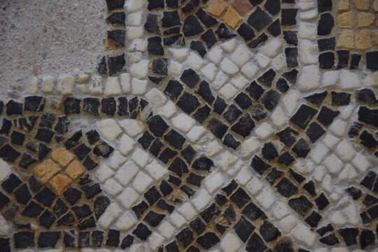 Ancient mosaic detail with interlocking geometric stone pattern