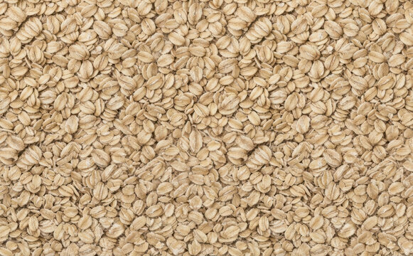 Rolled oats background texture closeup top view of healthy breakfast cereal grain food pattern