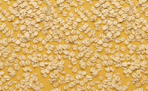 Rolled oat flakes background pattern texture top view healthy breakfast ingredient whole grain nutrition organic food concept flat lay