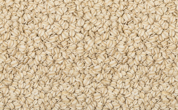 Rolled oats background texture pattern close up, healthy breakfast food ingredient concept for organic diet, natural whole grain cereal background design