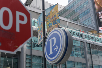 Obraz premium stop and parking sign at Edward St and Yonge St with view of The Tenor a shopping mall at 10 Dundas E (Yonge St side), Toronto