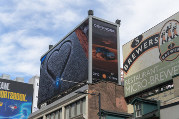 Obraz premium rooftop billboard featuring ads and store signs south of Sankofa Square (3 Brasseurs MicroBrewery, 275 Yonge St), Toronto