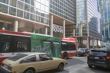 Obraz premium traffic outside Berczy Square, a business center, located at 33 Yonge Street, with view of a TTC bus and wrap ad for Steam Whistle brewery, Toronto
