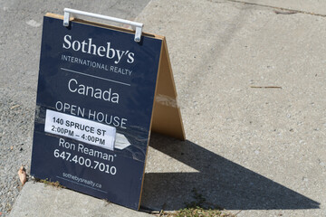 Obraz premium sidewalk a-frame sign of Sotheby's International Realty on Gerrard St E in Toronto