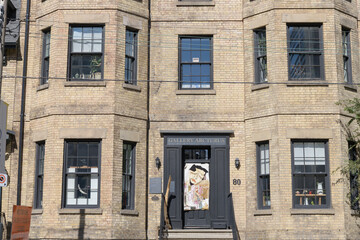 Obraz premium facade of a historic building and sign outside Gallery Arcturus located at 80 Gerrard St E, Toronto